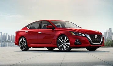 2023 Nissan Altima in red with city in background illustrating last year's 2022 model in Destination Nissan in Albany NY