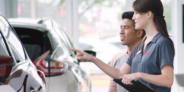 customer looking at a car